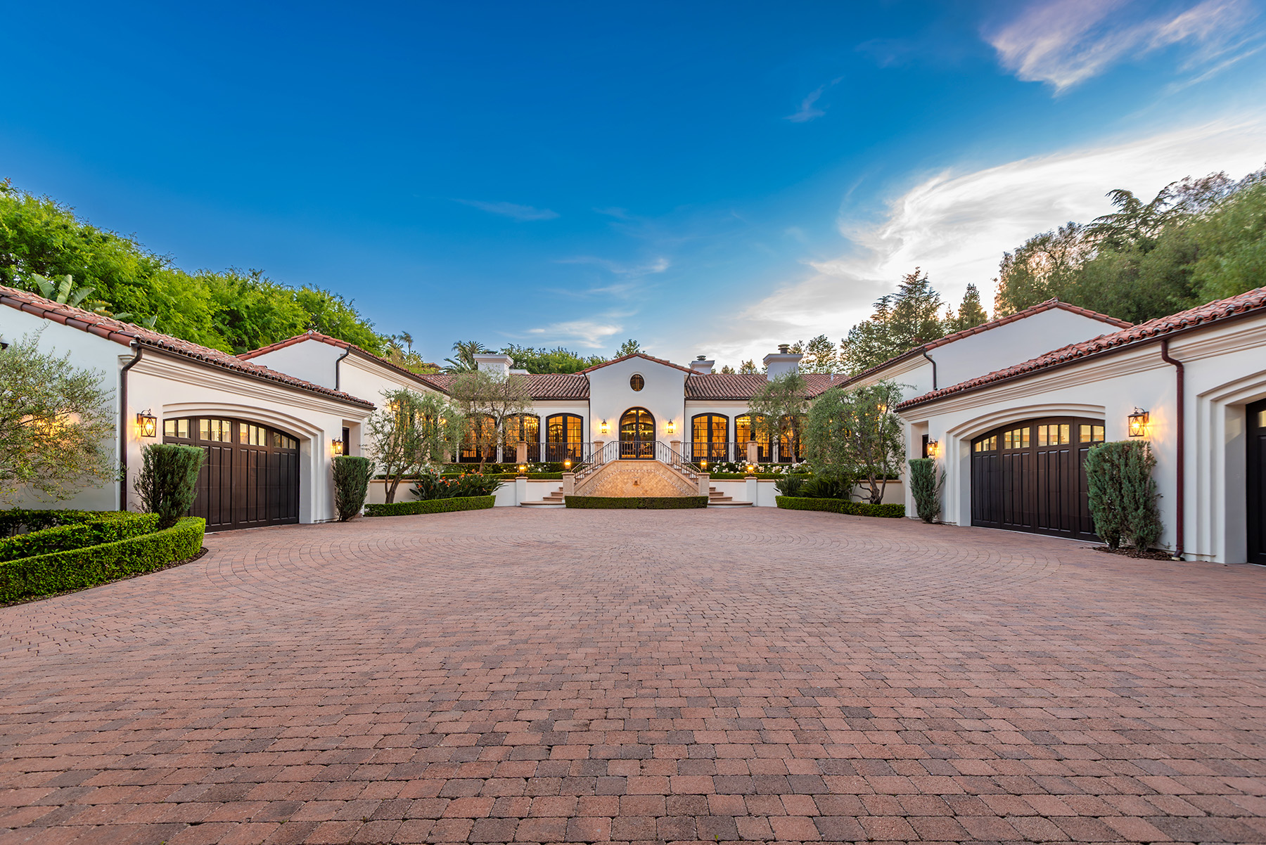 Luxury modern home exterior during golden hour with warm natural lighting